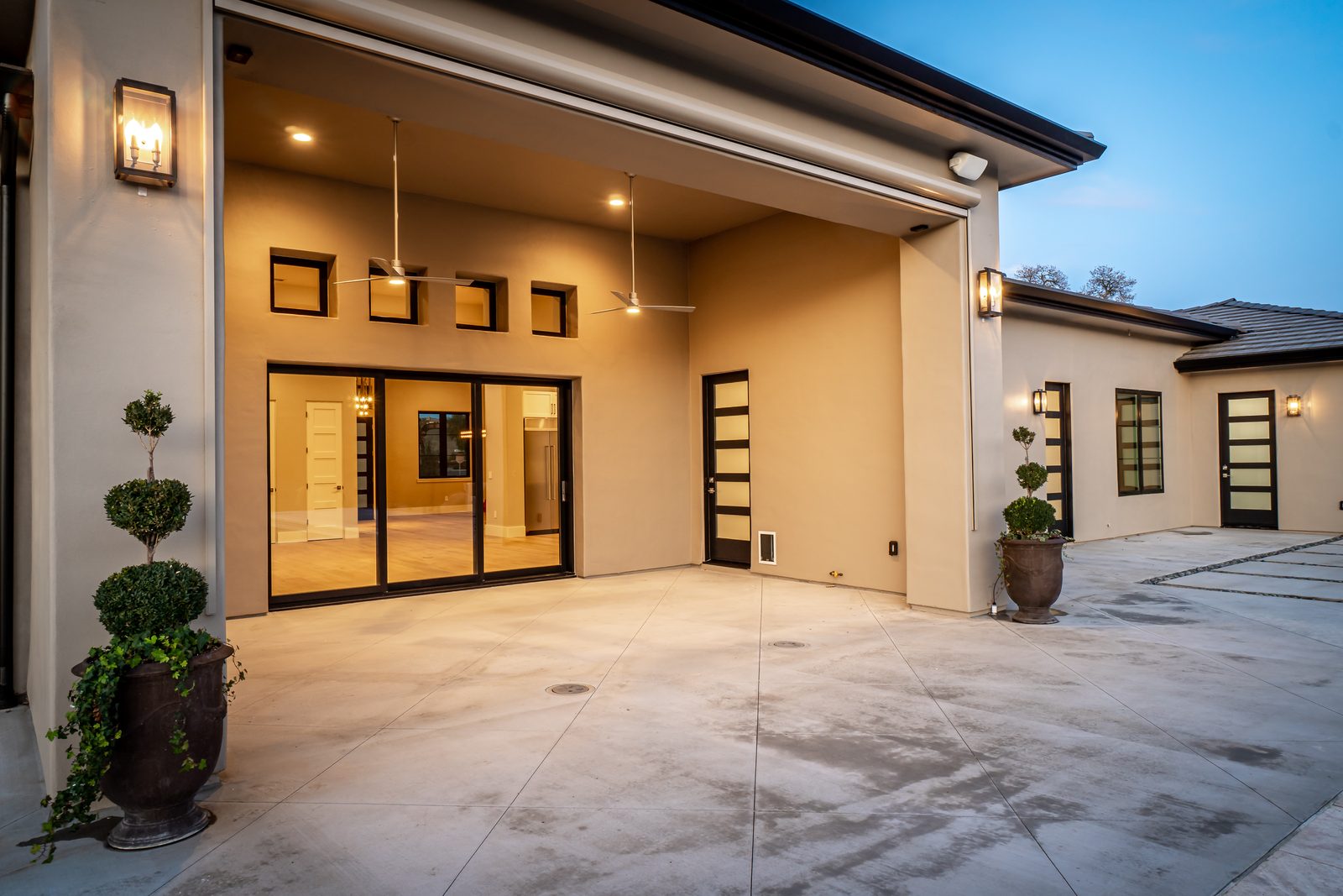 Covered patio with ceiling fans and sliding glass doors into the house, Templeton