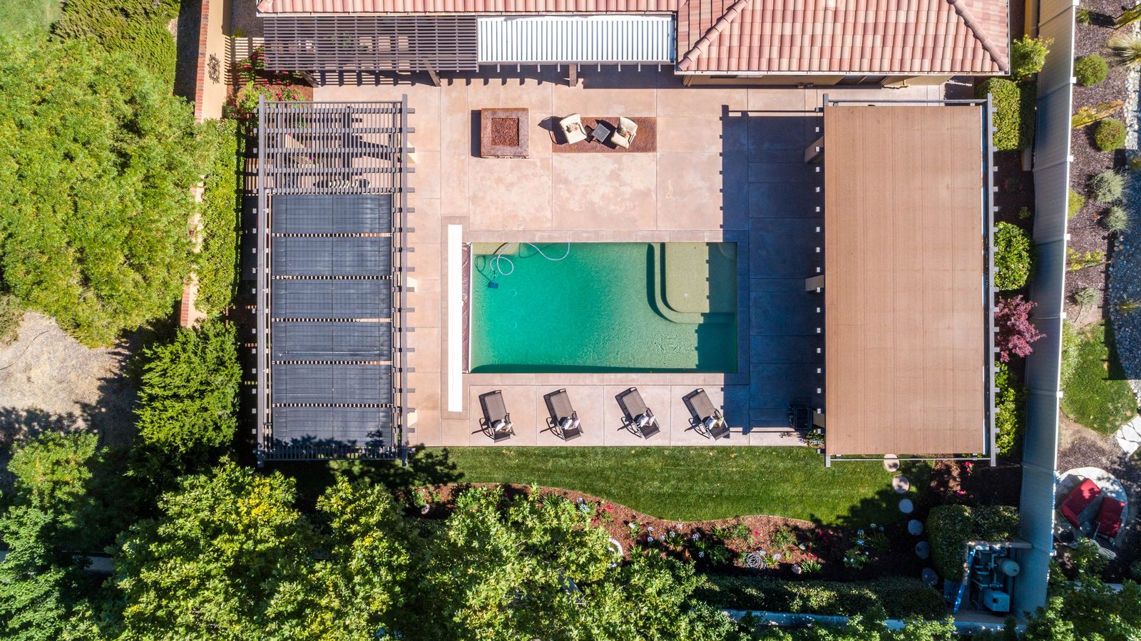 Overhead view of a tile-roof home with a pool, covered patios and a pergola, Paso Robles