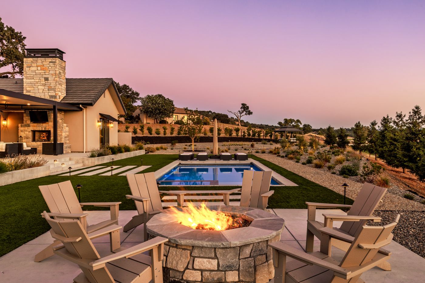 Stone fire pit and pool at dusk, Modern Ranch, Templeton